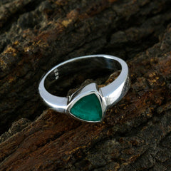 Violet brand silver green solitaire ring with triangular green gemstone on textured bark background