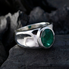 Antonia green solitaire ring with a polished silver band and oval emerald stone