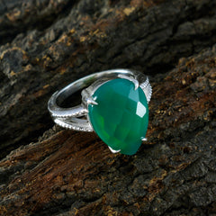 Sophia green solitaire ring with pear-shaped faceted green stone set in silver band on textured wood