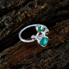 Nisa silver green toi et moi ring with pear and round green cabochon stones on wood background