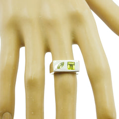 Lourdes green toi et moi ring with two green gemstones set in modern silver band on finger