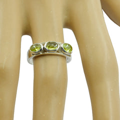 Ha-eun green trilogy gemstone ring with three round green stones set in silver band on finger
