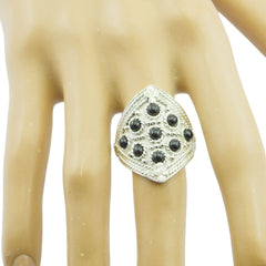 Araya heritage black statement ring in silver tone with clustered black stones on a model hand
