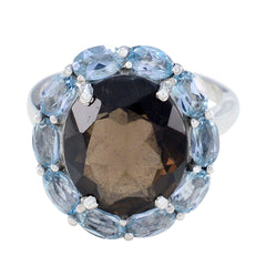 Hannah abstract multicolor gemstone ring with large dark center stone surrounded by light blue oval gems