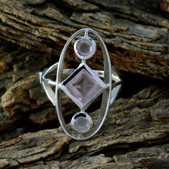 Lucia abstract pink gemstone ring with geometric design set in silver on textured wooden background