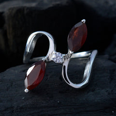 Lili abstract red gemstone ring featuring two marquise red stones and a central clear gem in silver setting