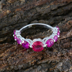 Hyejin sterling silver abstract red navratna ring with central round red stone and six smaller pink stones on bark