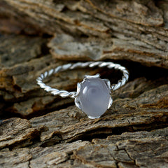 Putri elegant aqua solitaire ring with twisted silver band on rustic wooden background