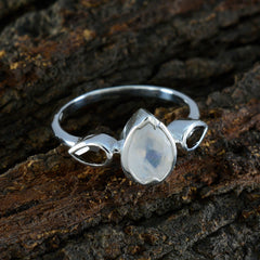 Kristine artisan trilogy ring silver band with pear moonstone center and two teardrop side stones on bark