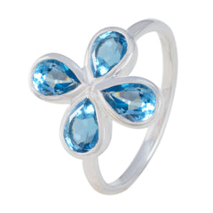 Yan sterling silver ring with four pear shaped blue topaz petals forming a flower blue floral gemstone ring for daily wear
