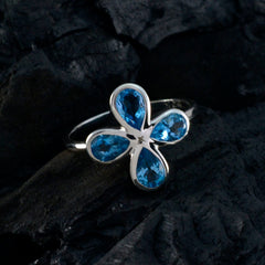 Yan silver band blue floral gemstone ring with four teardrop blue stones forming a delicate flower design