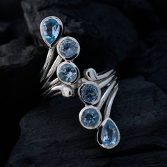 Putri blue gemstone statement ring with multiple oval and round blue stones set in silver band