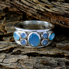 Isabelle silver blue gemstone statement ring with multiple oval blue stones on rustic wood background