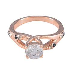 Isabel rose gold ring with blue gemstone statement ring design and clear central stone