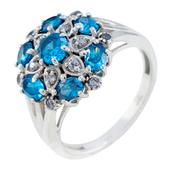 Nisa blue gemstone statement ring with multiple round blue and clear stones set in silver band
