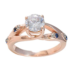 Isabel ring with blue gemstone statement ring design featuring a large clear center stone and smaller blue stones