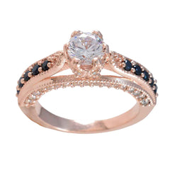 Julia blue halo gemstone ring with a central clear stone and blue and white accented bands in rose gold