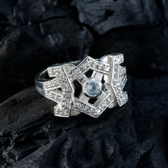 Elegant blue halo ring for women with silver intricate design and sparkling stones by Maria