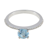 Maria silver ring with a sparkling blue halo ring center stone and small diamonds on the band