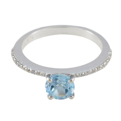 Maria silver ring with a sparkling blue halo ring center stone and small diamonds on the band