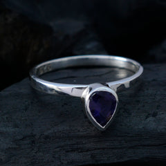 Mei silver ring featuring a blue solitaire gemstone ring with a teardrop-shaped stone on dark background