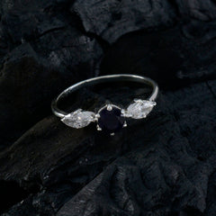 Ava blue trilogy gemstone ring with central blue gemstone and two clear side stones on silver band