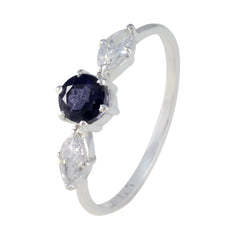 Ava blue trilogy gemstone ring featuring a central blue gemstone with two clear side stones in a silver band