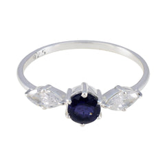 Ava silver blue trilogy gemstone ring with a round blue center stone and two clear side stones