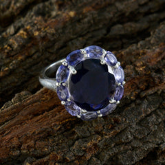 Lucia contemporary blue gemstone ring with dark center stone and lighter blue oval accents on silver band