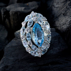 Tereza contemporary blue gemstone ring featuring a marquise-cut center stone surrounded by clear marquise gems