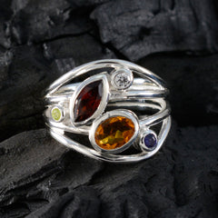 Laura contemporary multicolor gemstone ring with red, orange, purple, and clear stones set in silver band