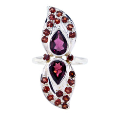 Natcha contemporary red gemstone ring with two pear shaped garnets and round red stone halo in silver