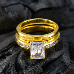 Ayesha gold band set featuring a contemporary white stone ring with emerald cut center and pave band