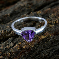 Isadora geometric purple solitaire ring with silver band on textured bark background