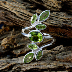 Araya silver ring featuring green gemstone leafy ring design with multiple green stones on rustic wood background