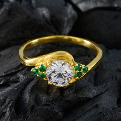 Araya gold ring with central round clear stone and small emerald clusters on each side green gemstone romantic ring