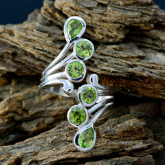 Riya silver ring with multiple peridot stones in teardrop and round settings on rustic wood green gemstone statement ring