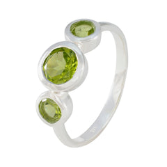 Lily sterling silver green gemstone trilogy ring with three bezel set peridot stones on polished band