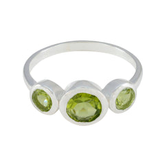 Lily silver green gemstone trilogy ring with central round peridot and two smaller bezel set stones for everyday wear