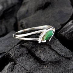 Hye-jin elegant silver green solitaire ring with marquise cut green gemstone on dark textured background