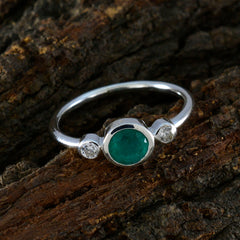 Rina green trilogy ring with a central green gemstone and two clear side stones on silver band