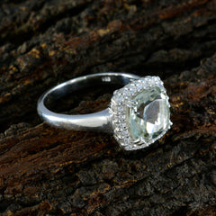 Lorena light green halo ring with silver band cushion cut center stone and diamond halo on wood
