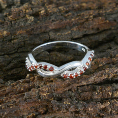 Sophia silver infinity twist ring with pave garnet accents on bark backdrop luxurious red gemstone ring