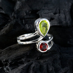 Ananya silver ring with green pear peridot and round red garnet luxurious toi et moi ring elegant split shank