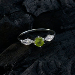 Hana modern green gemstone ring with a central green stone and two clear side stones on silver band