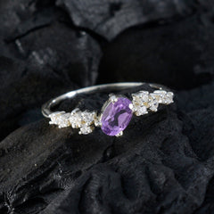 Lucy modern purple halo ring with a central purple gemstone and surrounding white stones on silver band