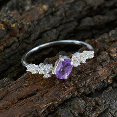 Lucy modern purple halo ring with oval purple gemstone surrounded by small clear stones on silver band