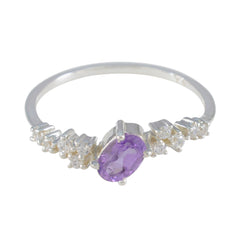 Lucy modern purple halo ring with an oval purple gemstone and small clear stones on silver band
