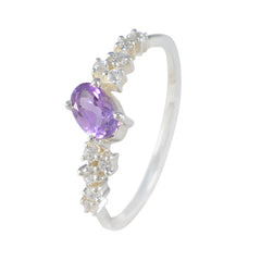 Lucy modern purple halo ring with oval purple gemstone and surrounding clear stones on silver band