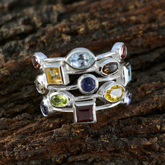 Hanna multicolor cocktail ring with various gemstone shapes set in silver band on rustic wood